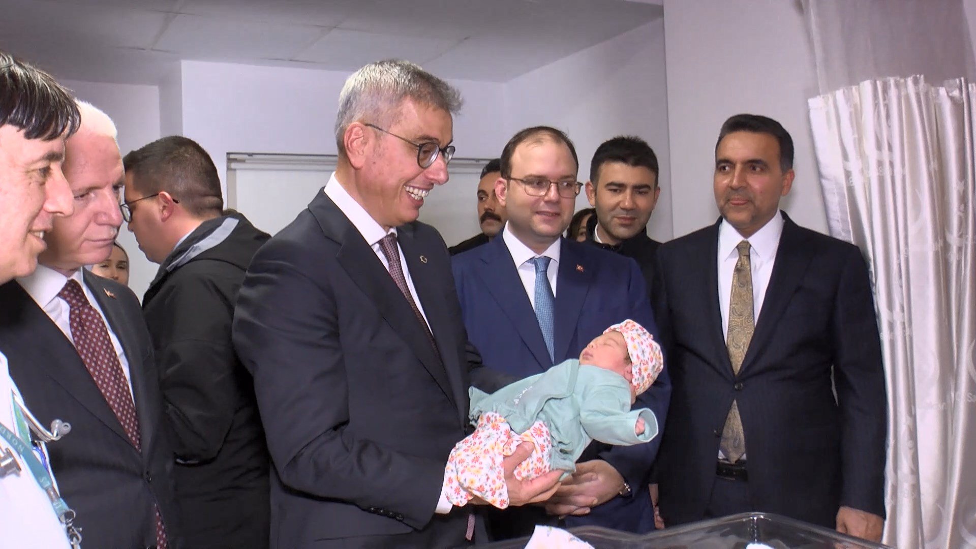 Bakan Memişoğlu Hümeyra bebeği kucağında tutarken