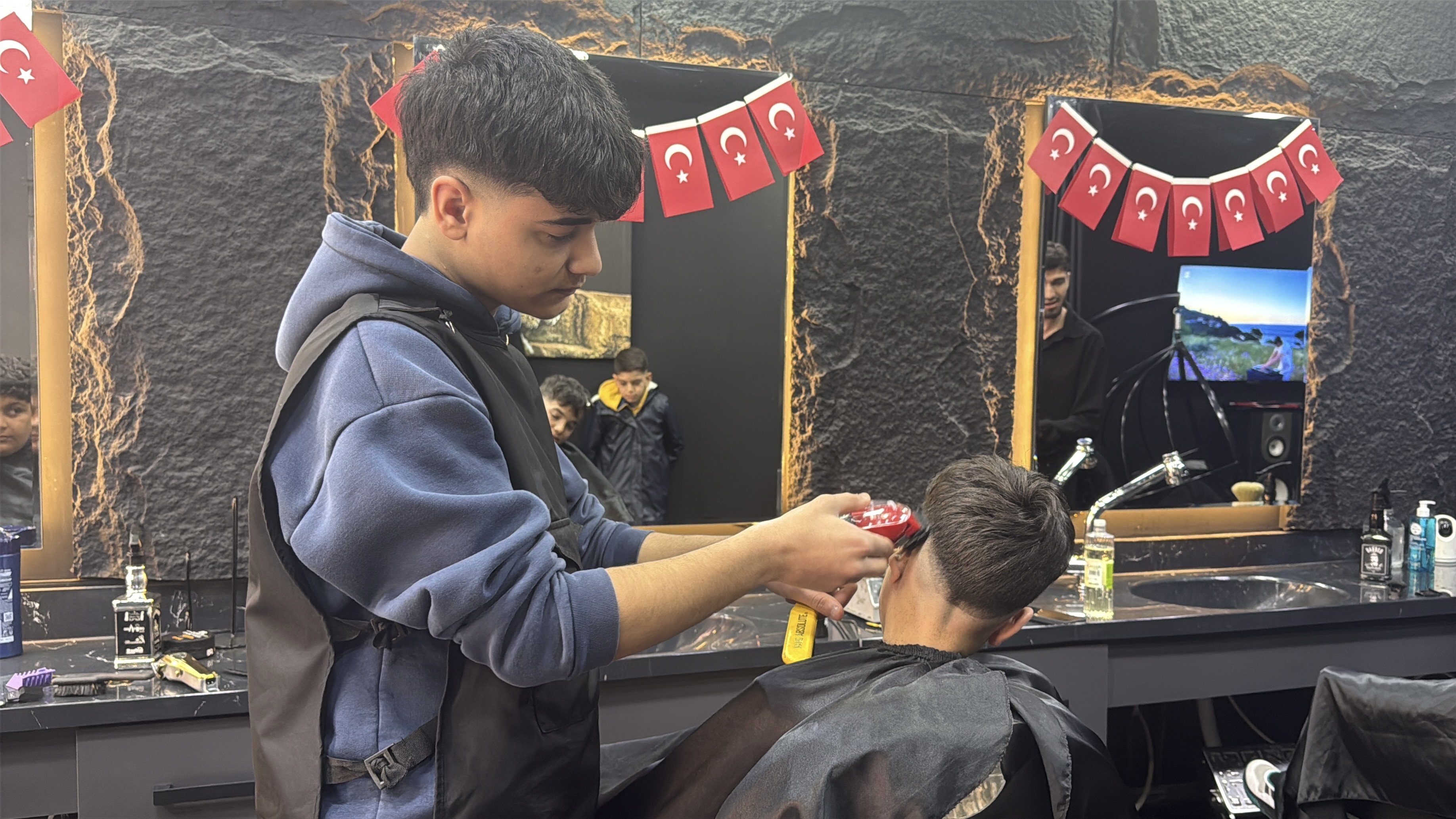 Berber dükkanında sıra bekleyen çocuklar